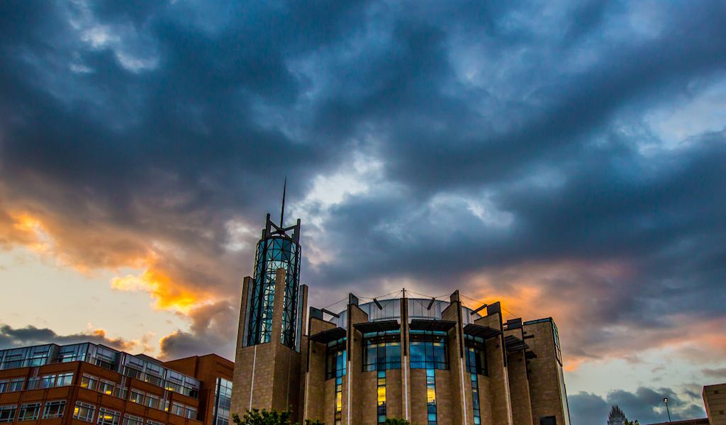 Charlotte academic building beneath clouds
