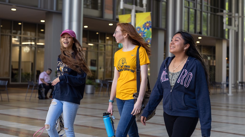 Three students walking together near campus